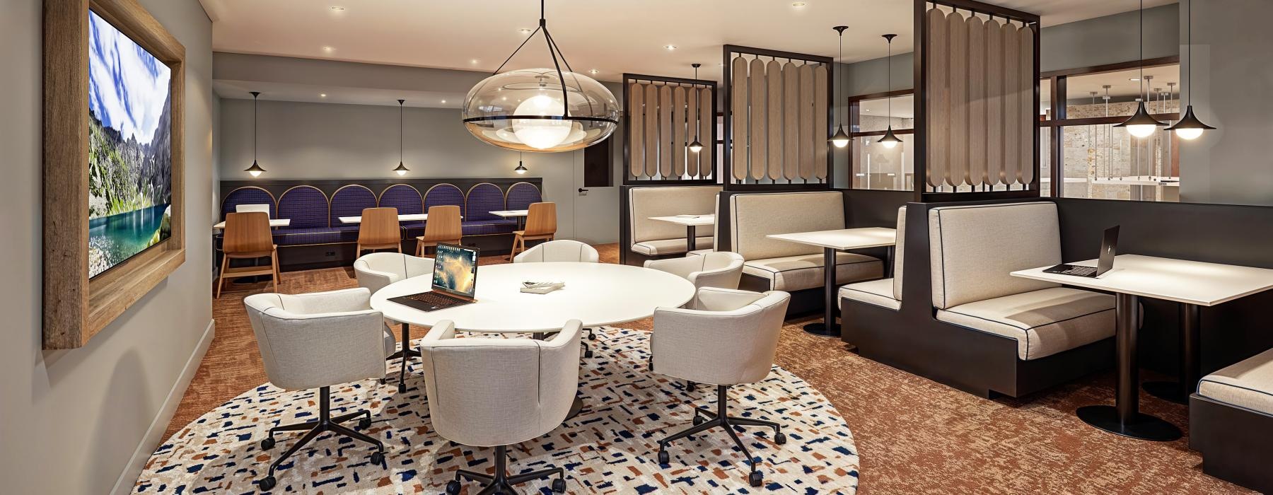 a room with a couch and chairs