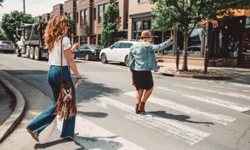 two women crossing a street