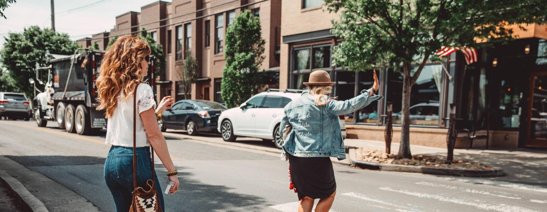 two women crossing a street